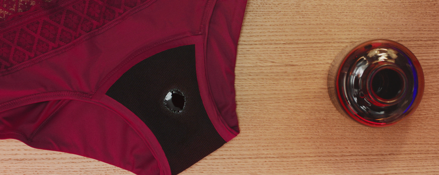 Close up of the absorbent gusset of Bodyform period pants with a drop of red liquid.