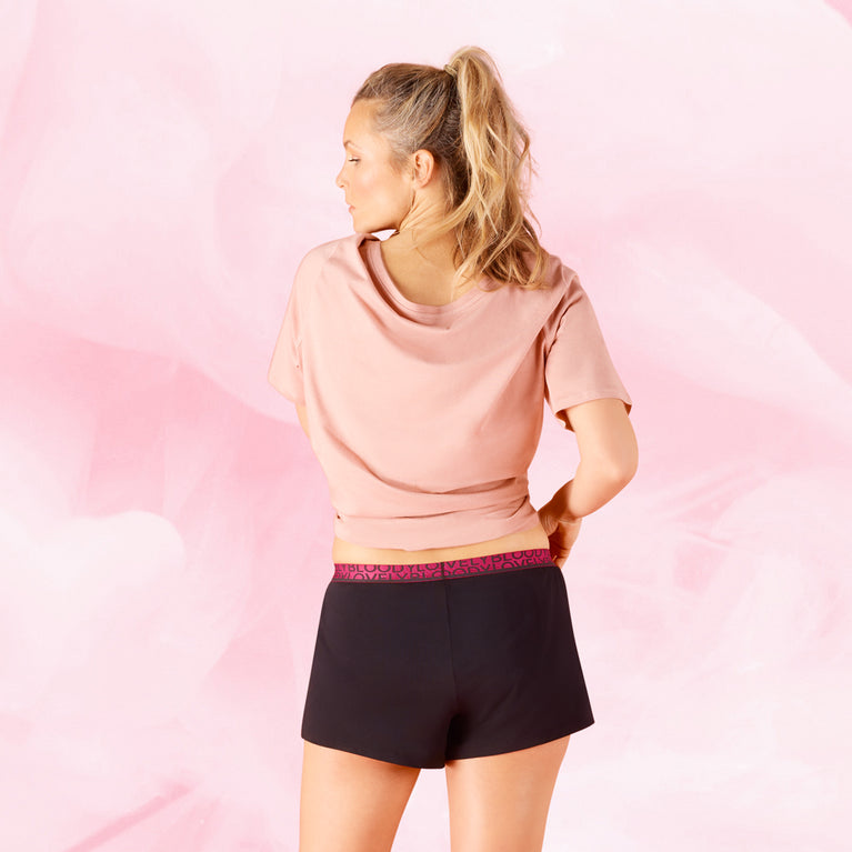 Woman wearing PJ Pants Overnight Sleepwear, showcasing stylish, protective period underwear designed for comfort and leak-free sleep in any position.