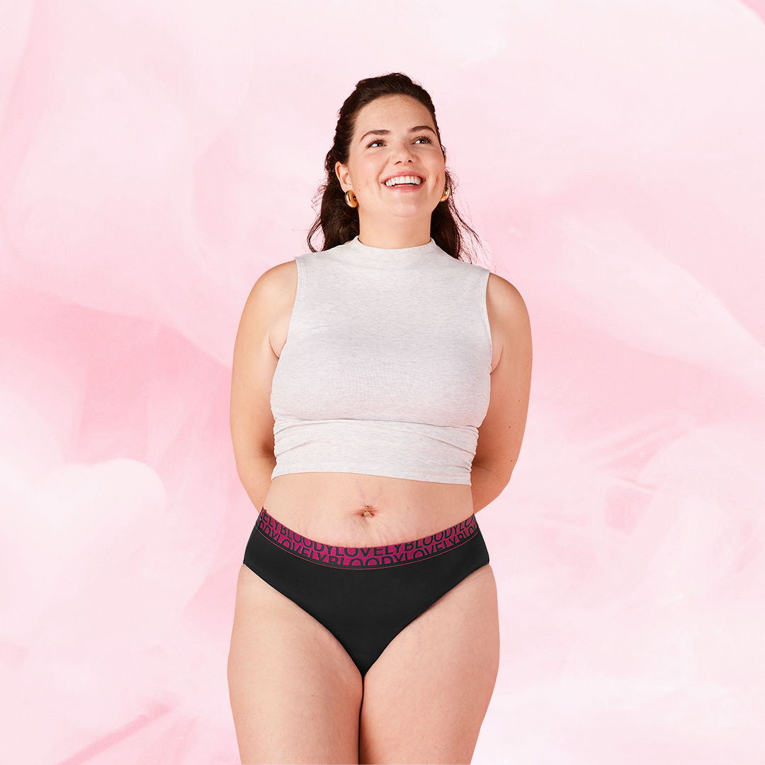 ComfortFit High Leg Heavy period pants modeled on smiling woman.