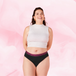 ComfortFit High Leg Light period pants modeled by a smiling woman.