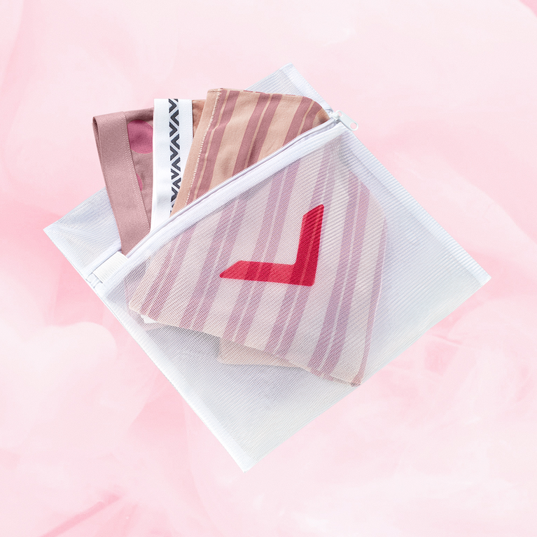 White mesh Laundry Bag with a red arrow design, designed to protect delicates in the wash. Features zipper closure to securely hold items.