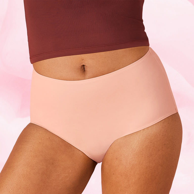 Woman wearing ComfortFit High Waist Light period pants, showcasing a close fit and high waist design for comfort and reliable protection.