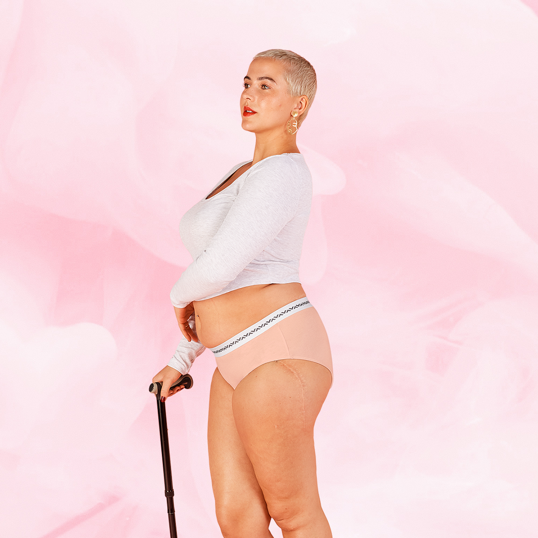 Woman in ComfortFit Essentials Hipster Logo Waistband Moderate period pants, showcasing the hipster cut and fit, emphasizing the product's comfort and protection features.
